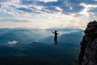 Image of person balancing on tightrope Image of person balancing on tightrope