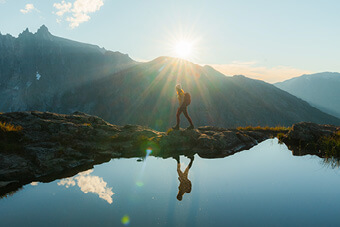 Person trekking across mountains Person trekking across mountains